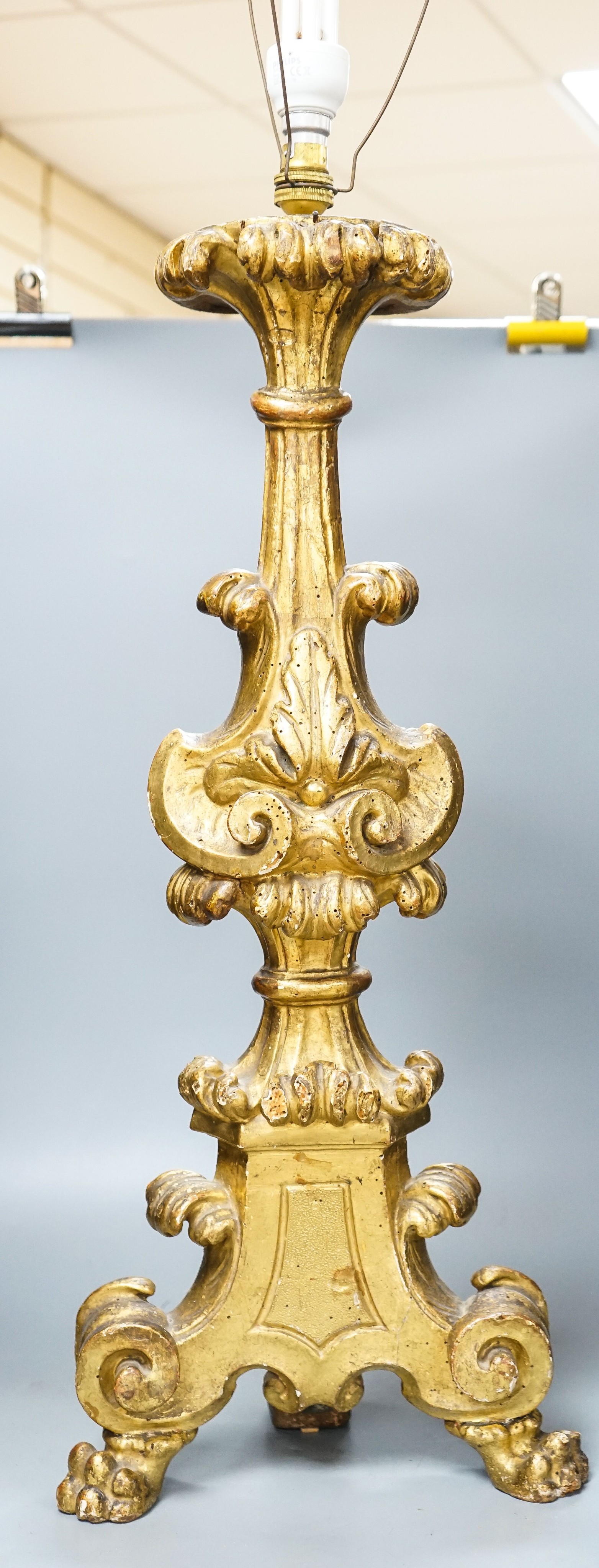 An 18th century Italian giltwood candlestand, foliate and scroll-carved